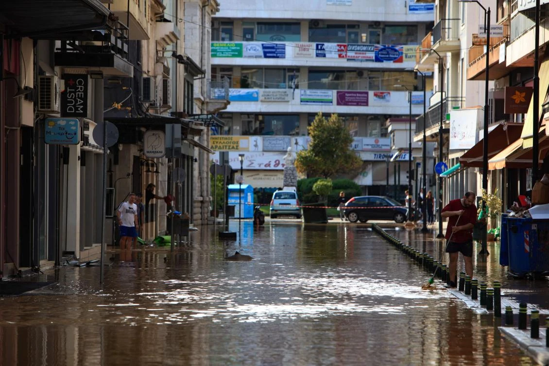 Residents clear mud from a road after the floods caused by the Mediterranean hurricane (Medicane) Ianos in Karditsa, central Greece, on September 19, 2020. Two people were found dead and another person was missing on September 19, 2020, after central Greece was lashed by a rare hurricane-like storm known as a "medicane". / AFP / Kostas Mantziaris