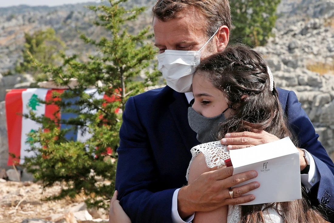 French President Macron comforts a Beirut blast victim during his visit to Lebanon on Tuesday. (AFP)