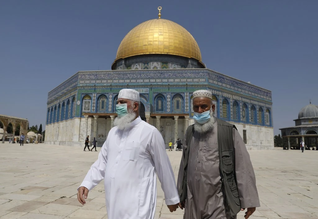 Palestinian Muslim worshippers wear face masks amidst the Covid-19 pandemic as they walk at the al-Aqsa mosque compound in the old city of Jerusalem on September 18, 2020. (File/AFP)