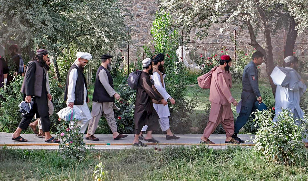 In this photograph released by Afghanistan's National Security Council (NSC), Taliban prisoners walk as they are in the process of being released from Pul-e-Charkhi prison on the outskirts of Kabul on Aug. 13, 2020. (Afghanistan's National Security Council (NSC) via AFP/File)
