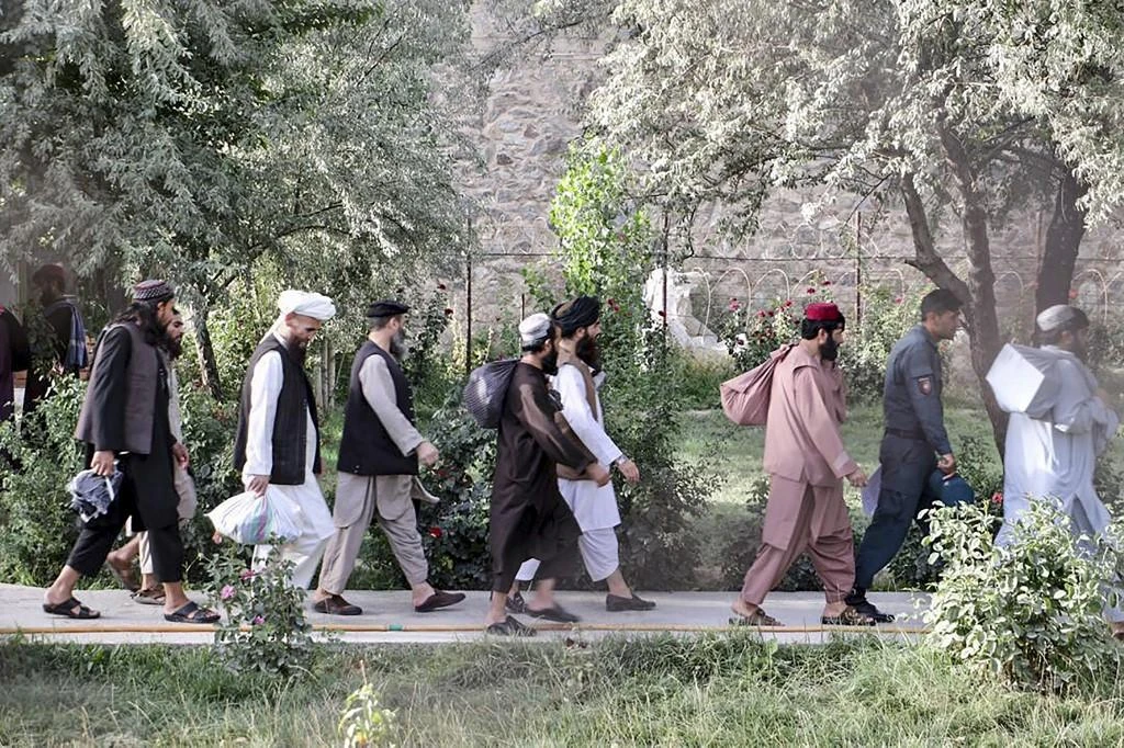 Handout photograph taken on August 13, 2020 and released by Afghanistan's National Security Council, NSC, Taliban prisoners walk as they are in the process of being released from Pul-e-Charkhi prison on the outskirts of Kabul. (File/AFP)