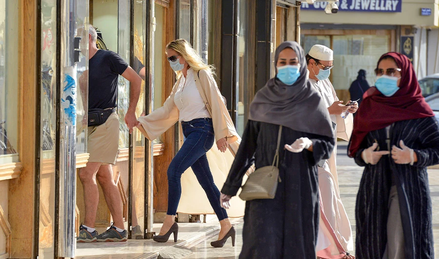 Shoppers walk past jewellery shops in the Taiba gold market in the capital Riyadh on June 29, 2020. (AFP)