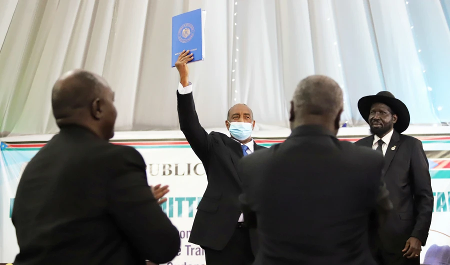 Sudan's Sovereign Council Chief General Abdel Fattah al-Burhan, next to South Sudan's President Salva Kiir Mayardit, lifts a copy of a signed peace agreement with the country's five key rebel groups, a significant step towards resolving deep-rooted conflicts that raged under former leader Omar al-Bashir, in Juba, South Sudan August 31, 2020. (REUTERS)