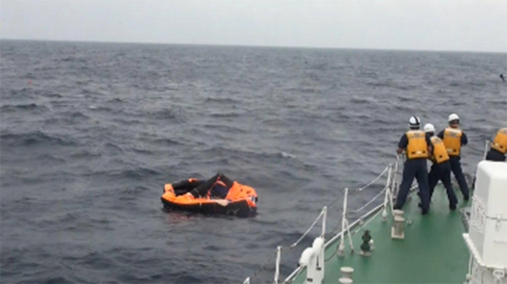 A Japanese Coast Guard vessel rescues a man from a life raft off Kodakarajima island in Kagoshima prefecture on Sept. 4, 2020. (Japan Coast Guard photo via AFP)