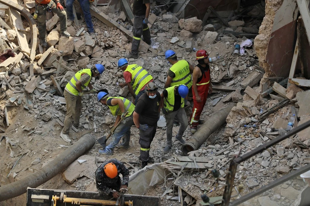 Rescue workers dig through the rubble of a badly damaged building in Lebanon’s capital Beirut after scanners detected a pulse on September 4, 2020. (AFP)