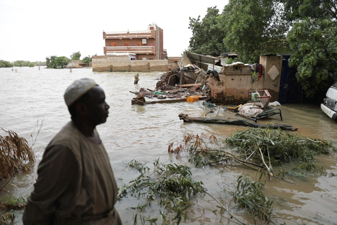 A man walks beside a flooded road in the town of Shaqilab, about 15 miles (24 kilometers) southwest of the capital, Khartoum, Sudan. (File/AP)