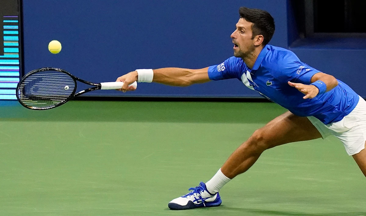 Novak Djokovic, of Serbia, returns a shot to Jan-Lennard Struff, of Germany, during the third round of the US Open tennis championships, Friday, Sept. 4, 2020, in New York. (AP)