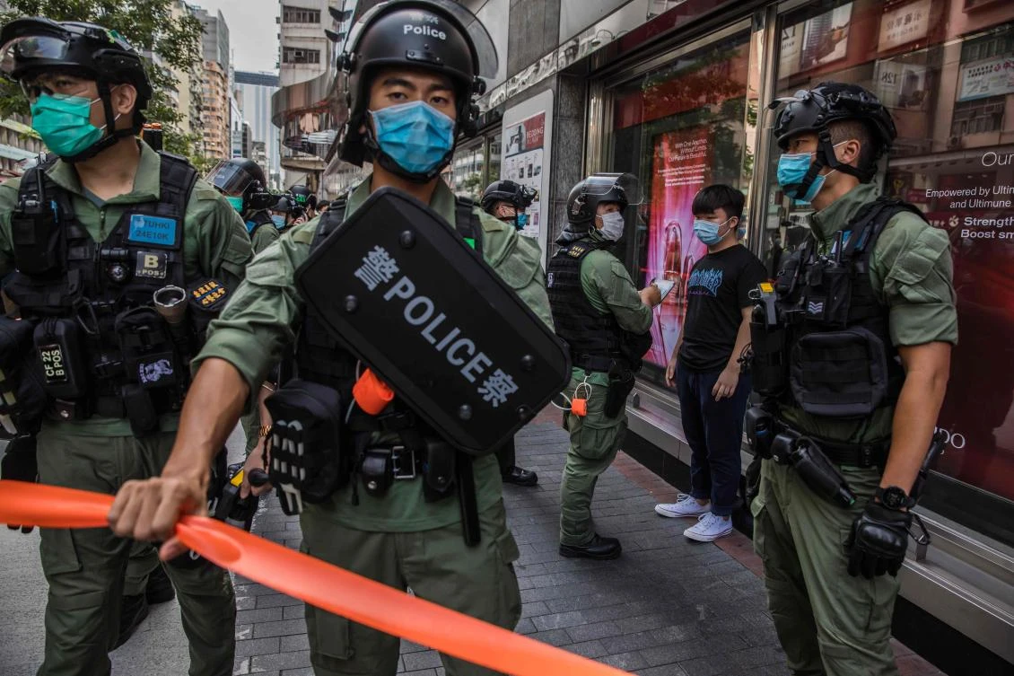 Hong Kong police question a resident as they patrol the area after protesters called for a rally on September 6, 2020. (AFP)