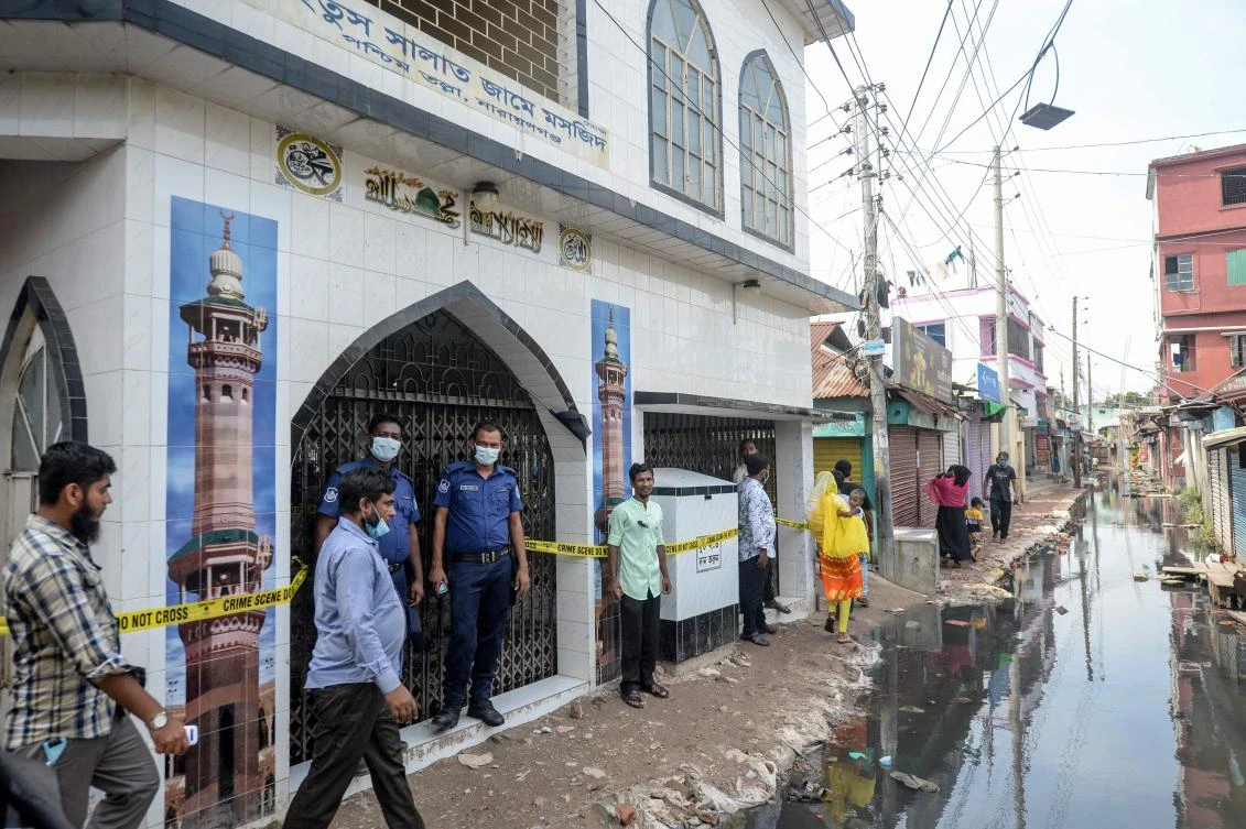 Police personnel stand guard in front of a mosque, following a fire accident, in Narayanganj on September 6, 2020. (AFP)