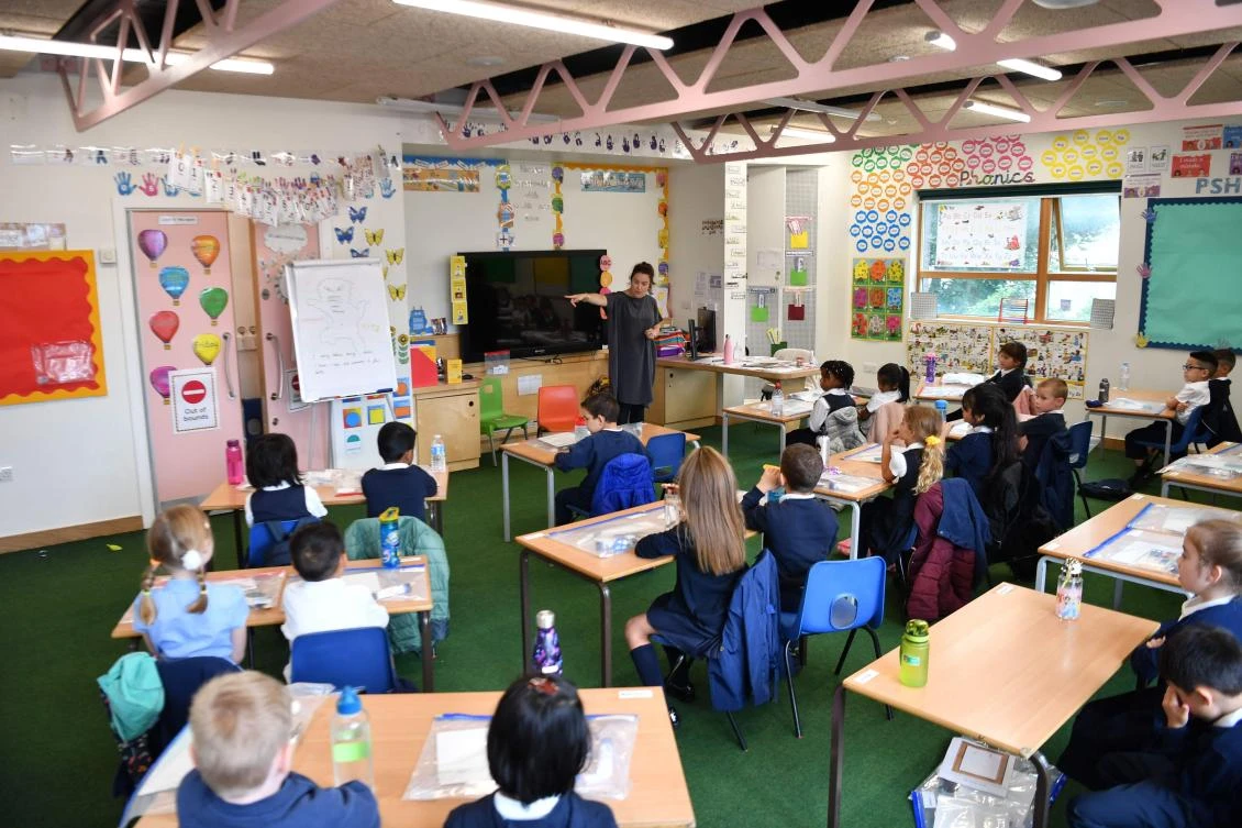 A teacher talks to her pupils during their first day of school after the summer break at St Luke's Church of England Primary School in East London. (File/AFP)