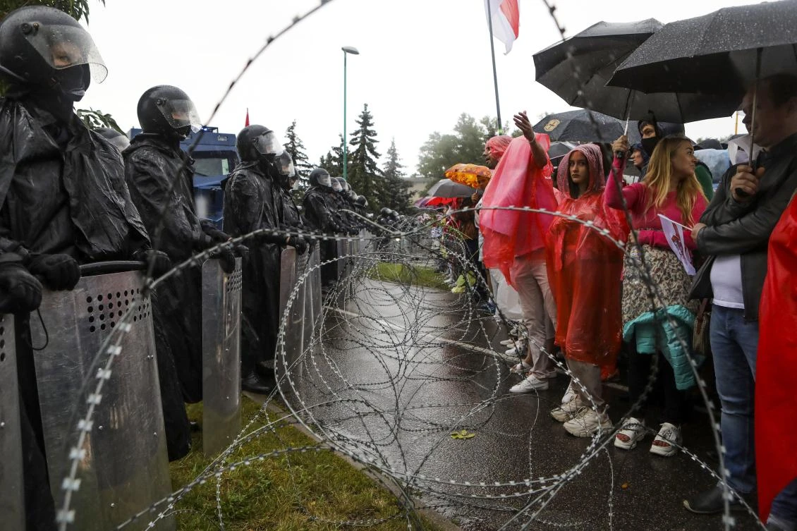 Protesters argue with police standing in front of a police barricade blocking opposition rally from moving toward the Independence Palace, residence of the President Alexander Lukashenko in Minsk, Belarus, Sunday, Sept. 6, 2020. (AP Photo)