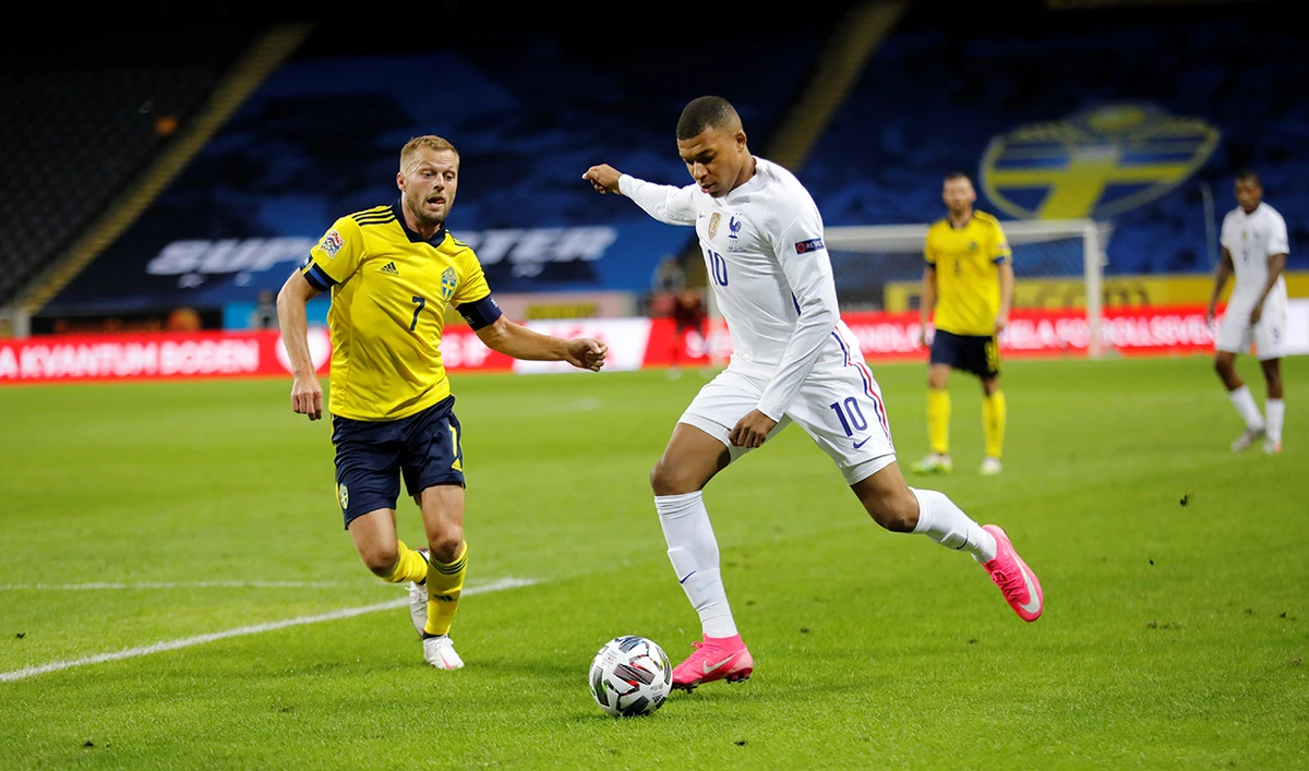 France’s forward Kylian Mbappe and Sweden’s midfielder Sebastian Larsson vie for the ball during the UEFA Nations League football match at the Friends Arena in Solna, near Stockholm. (AFP)