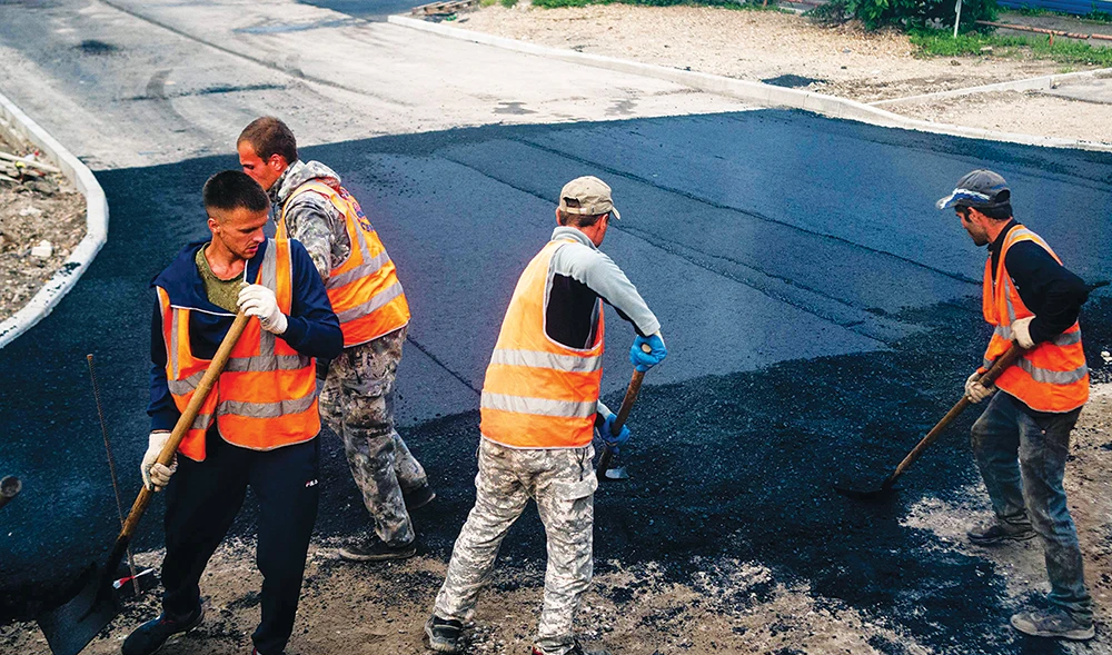 Workers repair a street in Svobodny. The Russian town had been vegetating in disrepair from the fall of the Soviet Union until the arrival of mega-projects. (AFP)