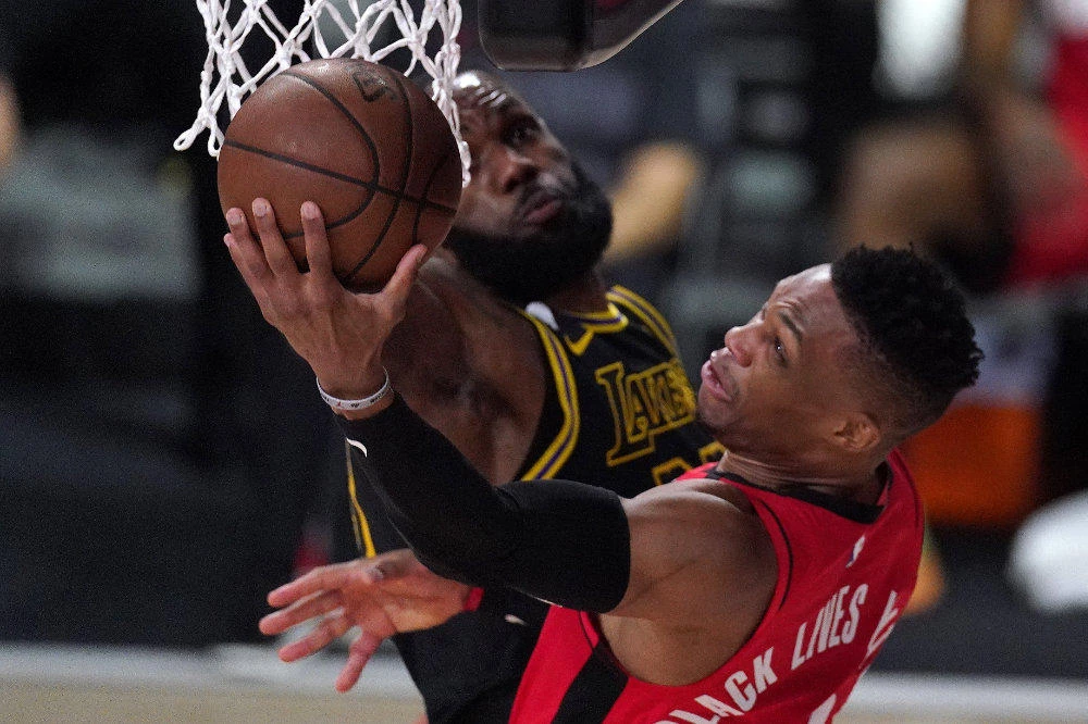 Houston Rockets' Russell Westbrook goes up for a shot against Los Angeles Lakers' LeBron James during the first half of an NBA conference semifinal playoff basketball game on Sept. 6, 2020, in Lake Buena Vista, Florida. (AP Photo/Mark J. Terrill)
