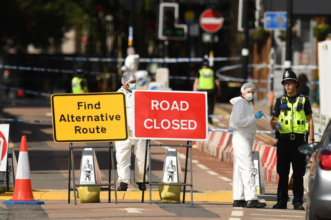 Forensics officers gather evidence inside a cordon on Hurst Street, following a major stabbing incident in the center of Birmingham on Sept. 6, 2020. (AFP)