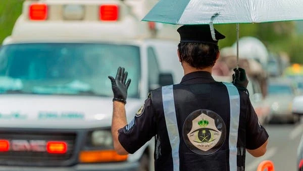 A Saudi security officer motions to an ambulance at a checkpoint in Makkah. (AP)