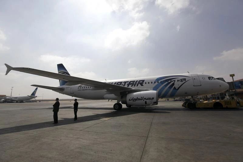Airport staff stand next to an EgyptAir plane on the runway at Cairo Airport, September 5, 2013. (File : Reuters)