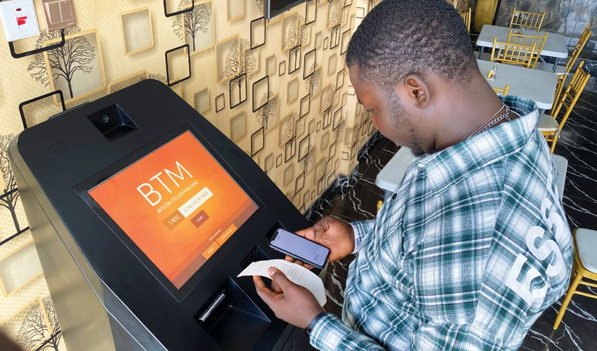 A bitcoin user checks receipts after buying the cryptocurrency in Lagos. A weaker Nigerian naira is pushing US dollars out of reach for many. (Reuters)