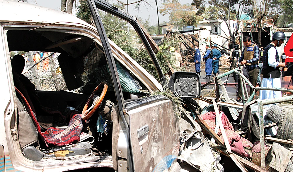 Afghan security personnel work at the site of an explosion in Kabul Wednesday. The Interior Ministry said the bombing targeted the Afghan VP. (AP)