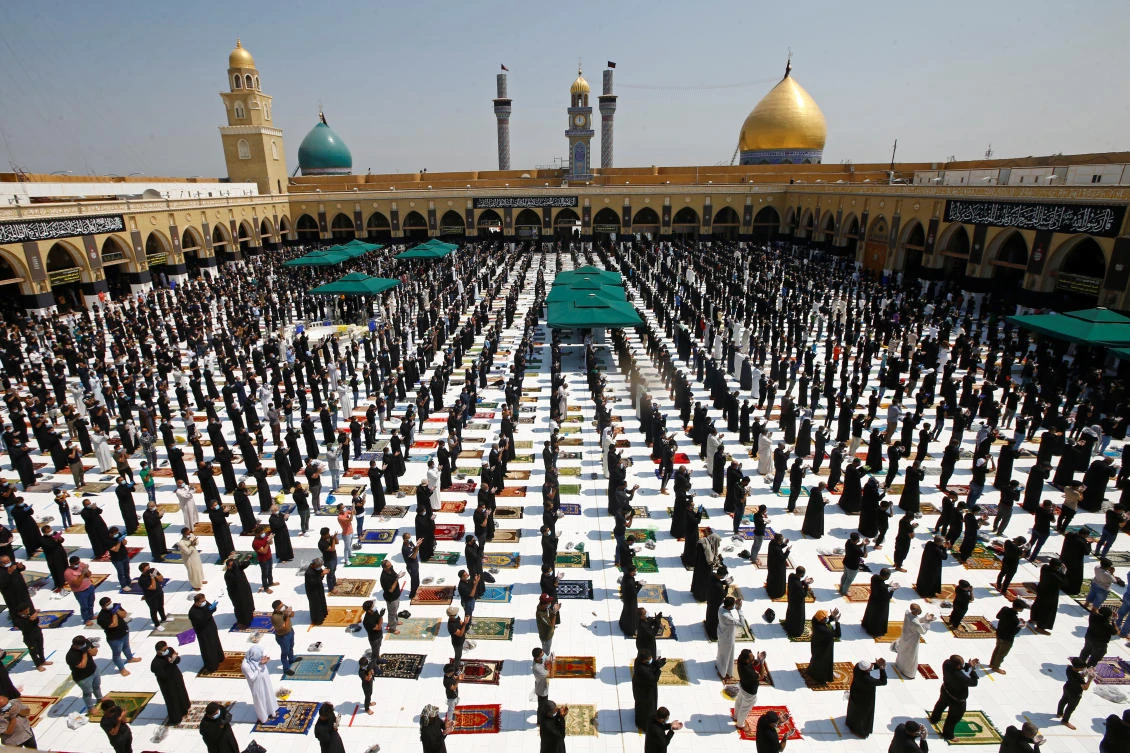 Supporters of Iraqi Shiite cleric Moqtada Al-Sadr maintain social distancing as they attend Friday prayers for the first time in months. (Reuters)