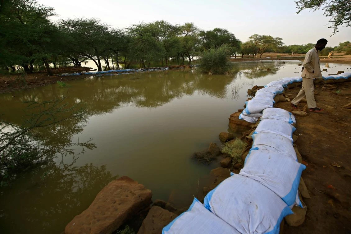A worker with the Sudanese antiquities authority lines a stone wall with sandbags to mitigate flood water damage to a structure in the ancient royal city at the archaeological site of Meroe, in the River Nile State’s Al-Bajrawia area, 300Km north of the capital, on September 9, 2020. (AFP/Ashraf Shazly)