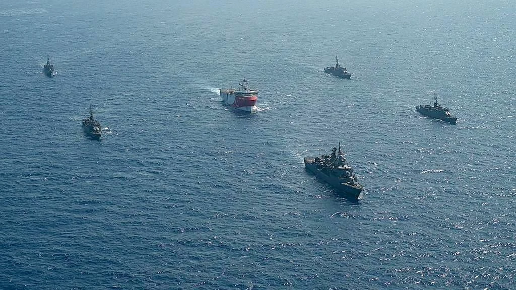 Above, the Turkish seismic research vessel Oruc Reis being escorted Turkish naval ships in the Mediterranean Sea on August 10, 2020. (Turkish Defense Ministry via AFP)