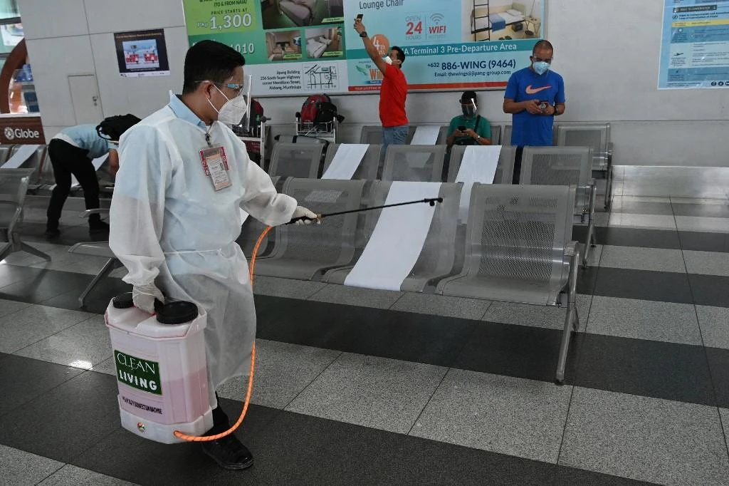 The Philippines’ confirmed coronavirus cases had risen to 261,216, the highest in Southeast Asia. Above, a worker disinfects chairs at the airport in Manila. (AFP)