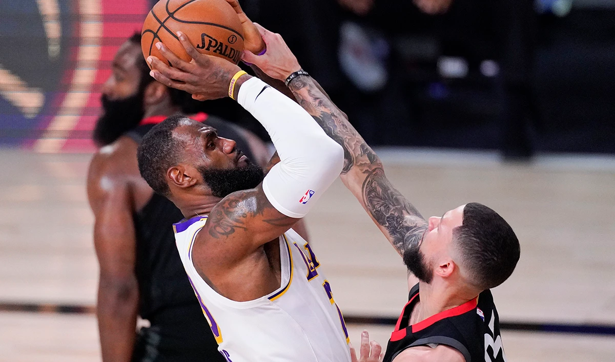 Los Angeles Lakers’ LeBron James, left, shoots over Houston Rockets’ Austin Rivers during the second half of an NBA game on Saturday in Lake Buena Vista, Fla. (AP)
