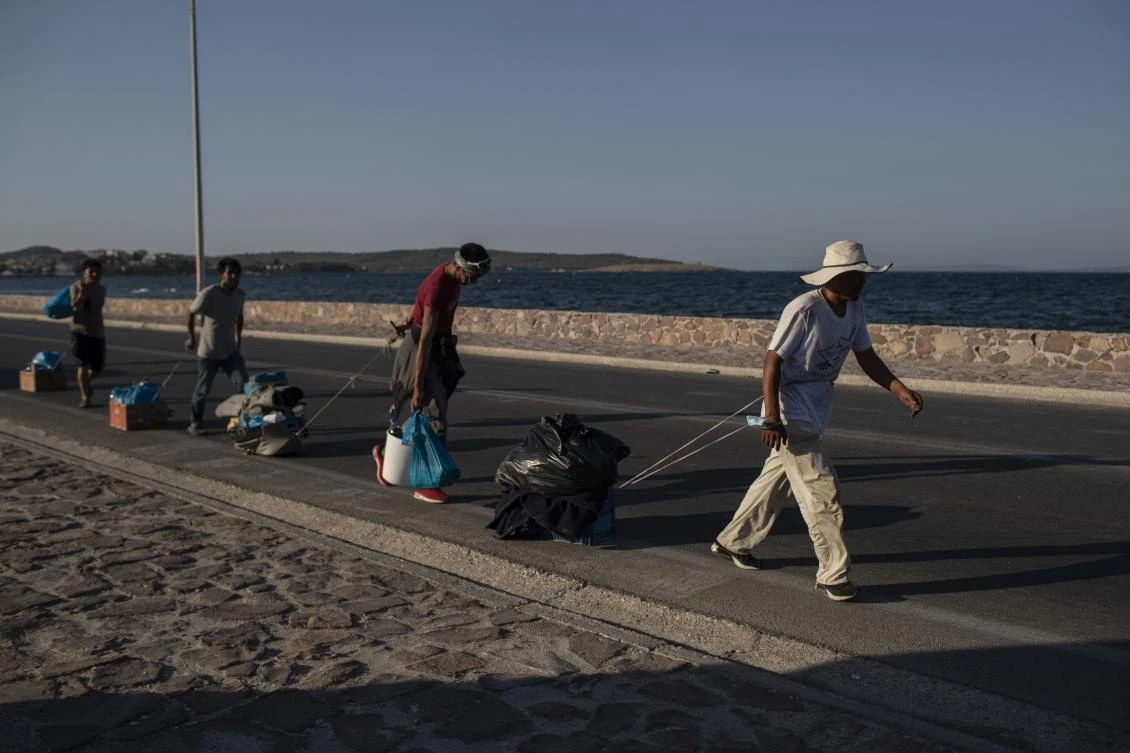 Greek police arrest 5 over Lesbos fire, migrants resist new camp