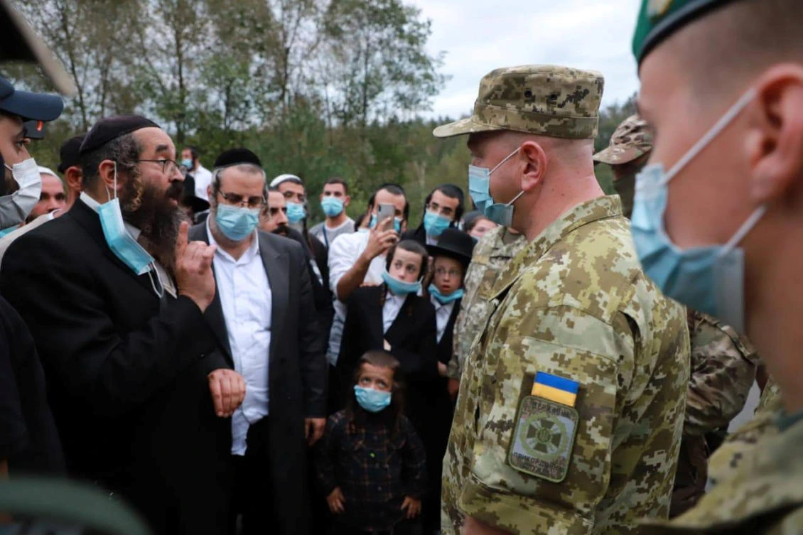 Ukraine’s border service head Serhiy Deineko speaks with Jewish pilgrims, who plan to enter Ukraine from Belarus, at Novi Yarylovychi crossing point in Chernihiv Region, Ukraine, Sept. 14, 2020. (Reuters)