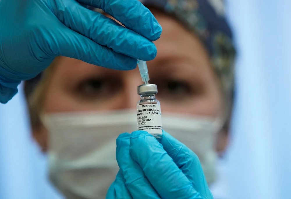 A nurse prepares Russia's "Sputnik-V" vaccine against the coronavirus disease (COVID-19) in a post-registration trials stage at a clinic in Moscow. (Reuters)