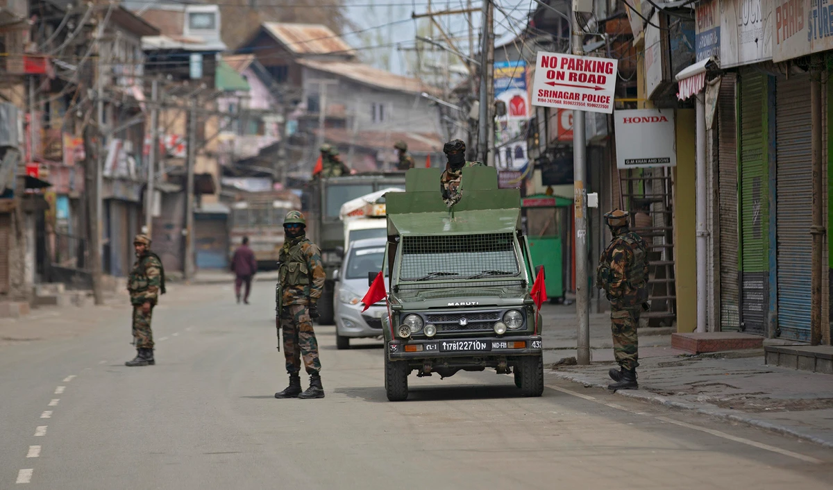 Indian army soldiers stand guard while they wait for a fellow soldier shopping during lockdown in Srinagar, Indian-administered Kashmir, on March 31, 2020. (AP/File)