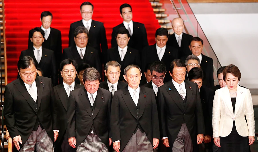 Japan’s Prime Minister Yoshihide Suga, center, with cabinet ministers this week. Suga’s plans for structural reforms will focus more on spurring competition, rather than deeper social change. (AP)