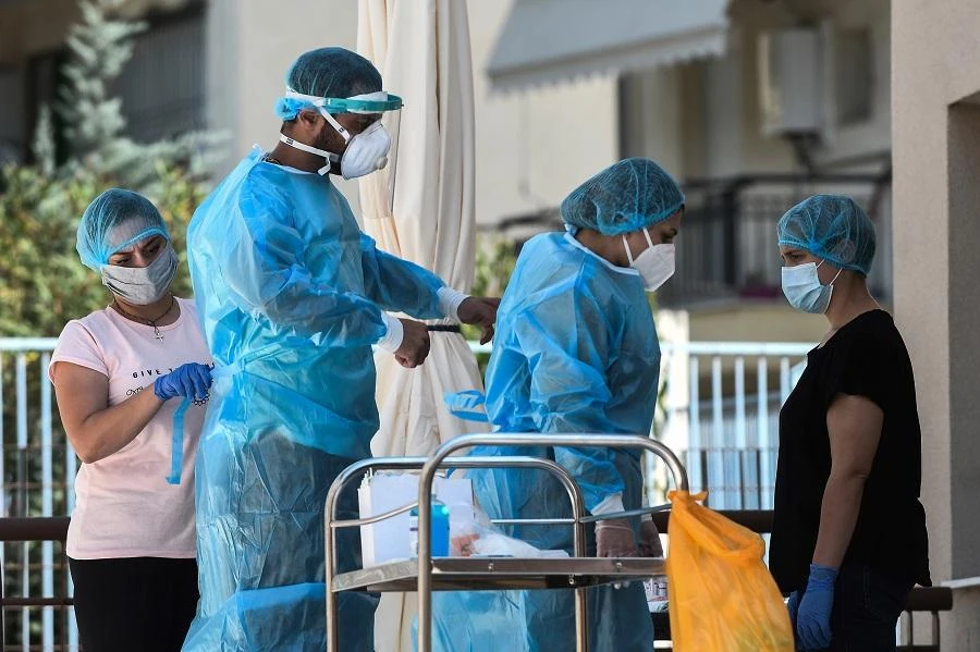 Public health workers wear protective suits and facemasks as they get ready to tests the residents and workers of a nursing home, where 13 people have been tested positive for the COVID-19 (the novel coronavirus) in Thessaloniki on August 19, 2020. (File/AFP)