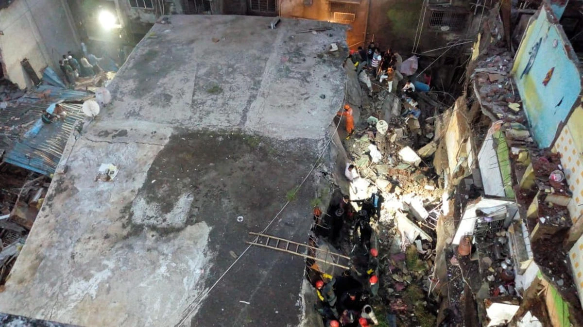 This photograph provided by India’s National Disaster Response Force (NDRF) shows rescuers at the site after a residential building collapsed in Bhiwandi in Thane district, a suburb of Mumbai, India, Monday, Sept.21, 2020. (AP)