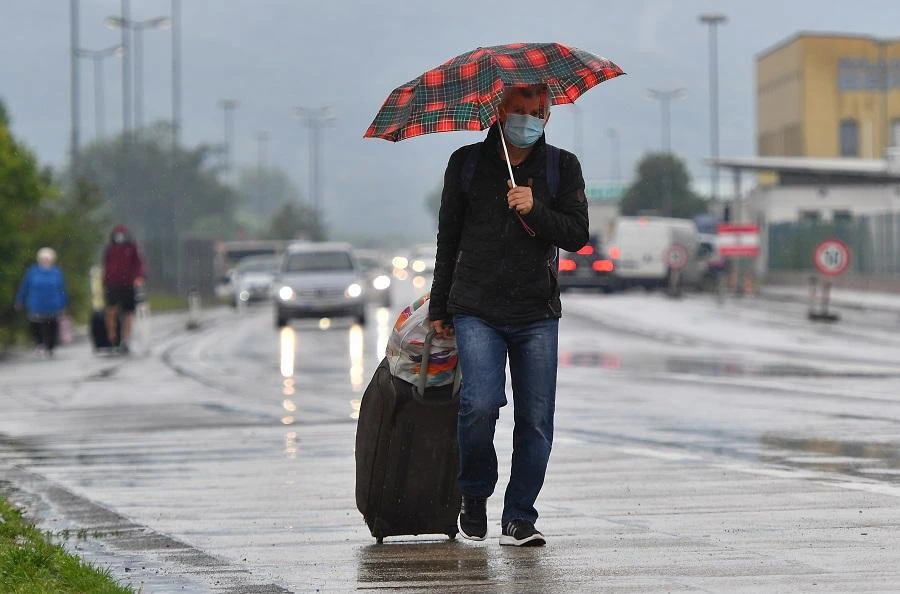 A Slovakian man returning to Slovakia rolls his luggage through the Bratislava-Berg border crossing between Austria and Slovakia amidst the new coronavirus COVID-19 pandemic on May 23, 2020. (File/AFP)