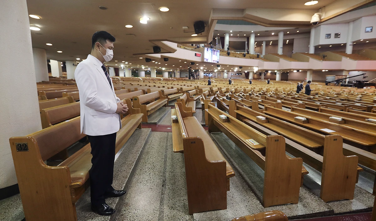 A pastor wearing a face mask to help protect against the spread of the coronavirus prays during a service at the Yoido Full Gospel Church in Seoul, South Korea, Sunday, Sept. 20, 2020. (AP)