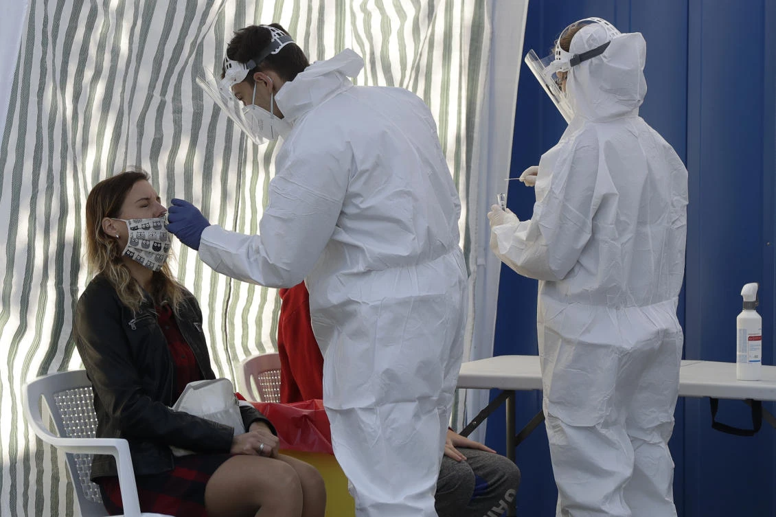 A woman gets tested for COVID-19 at a sampling station in Prague, Czech Republic, Monday, Sept. 21, 2020. The country coped well with the first wave of the coronavirus infections in the spring but has been facing a record surge of the new confirmed cases last week. (AP)