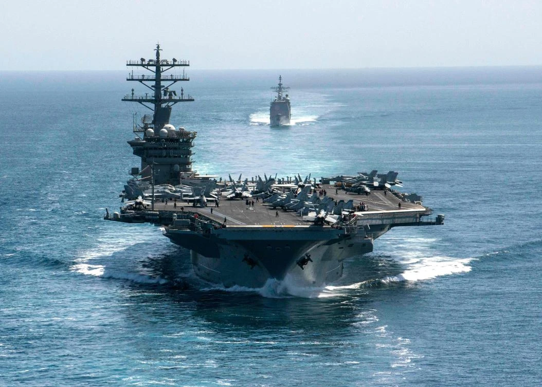 This handout photo courtesy of US Navy shows the aircraft carrier USS Nimitz (CVN 68) and the guided-missile cruiser USS Philippine Sea (CG 58) steam in formation during a Strait of Hormuz transit on September 18, 2020. (AFP)