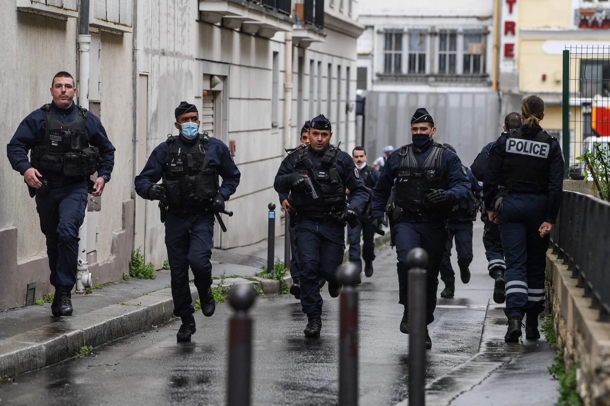 French police officers rush to the scene after people were injured near the former offices of the French satirical magazine Charlie Hebdo. (AFP)