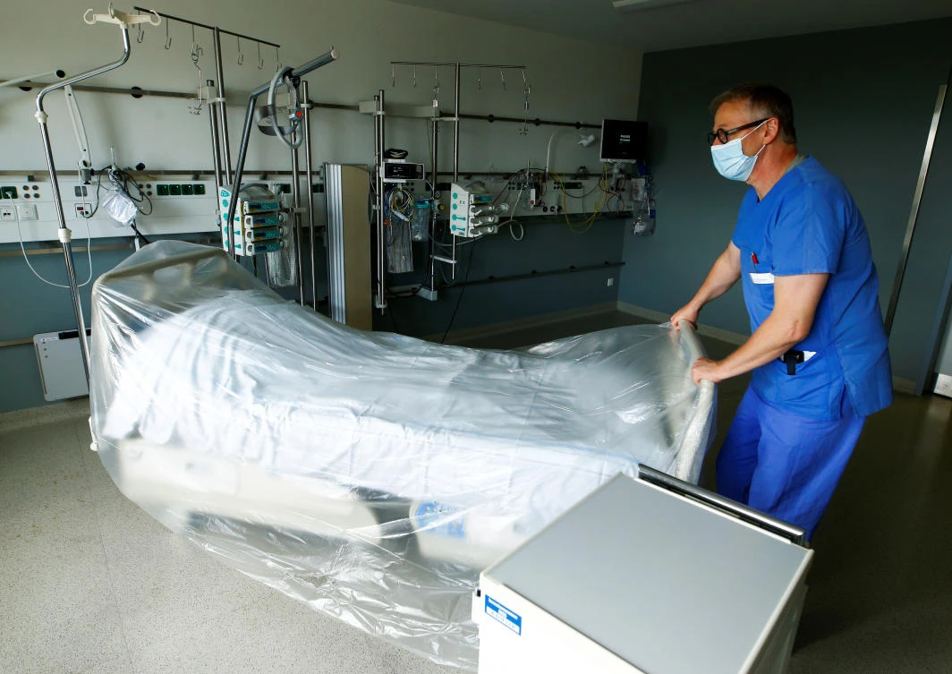 A member of the medical staff prepares a room reserved for patients suffering from COVID-19 in an intensive care unit at St.-Antonius-Hospital in Eschweiler, Germany, September 25, 2020. (Reuters)