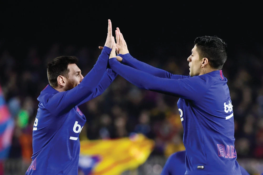 Barcelona’s forwards Lionel Messi and Luis Suarez warm up before the ‘El Clasico’ Spanish League football match against Real Madrid CF at the Camp Nou Stadium in Barcelona last year. (AFP file photo)