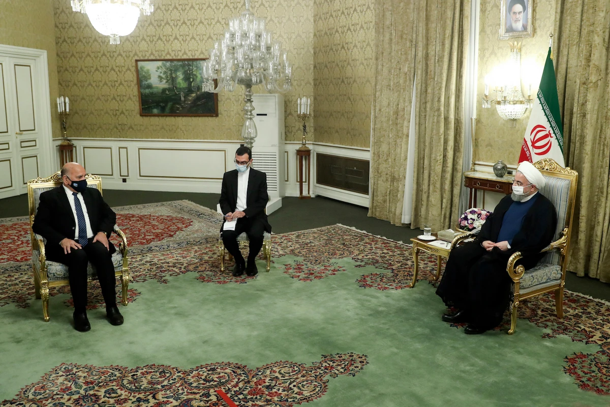 In this photo released by the official website of the office of the Iranian Presidency, President Hassan Rouhani, right, meets Iraqi Foreign Minister Fuad Hussein, left, in Tehran, Iran, Saturday, Sept. 26, 2020. (AP)