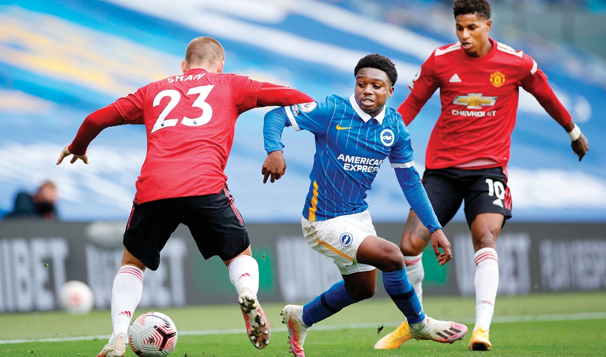 Brighton’s midfielder Tariq Lamptey vies with Manchester United’s defender Luke Shaw during Saturday’s Premier League match in southern England. (AFP)