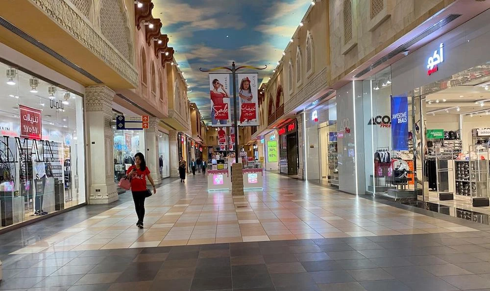 A woman walks in an almost empty mall amid the outbreak of coronavirus disease (COVID-19), in Dubai, UAE. (File/Reuters)