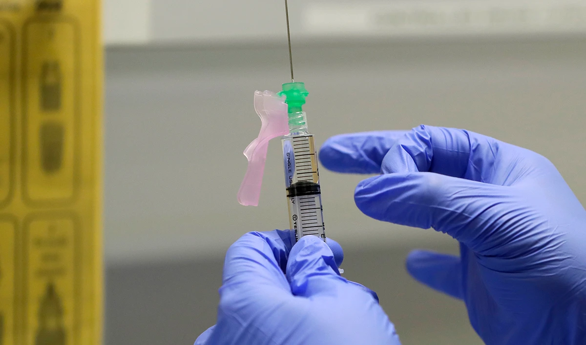 Senior Clinical Research Nurse Ajithkumar Sukumaran prepares the COVID 19 vaccine to administer to a volunteer, at a clinic in London. (AP/File)