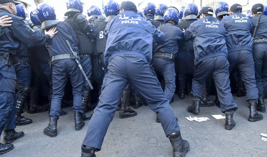 Members of the Algerian police block the progress of an anti-government demonstration heading towards the presidential palace in the capital Algiers, on February 22, 2020. (AFP)
