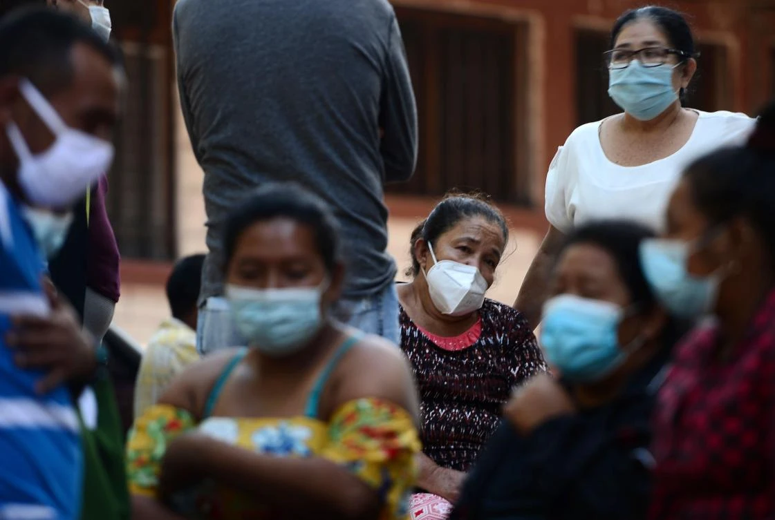 Relatives and friends wait for the remains of murdered Honduran journalist Luis Almendares, outside the Forensic Medicine Board headquarters in Comayagua, Honduras, on September 28, 2020. (AFP)