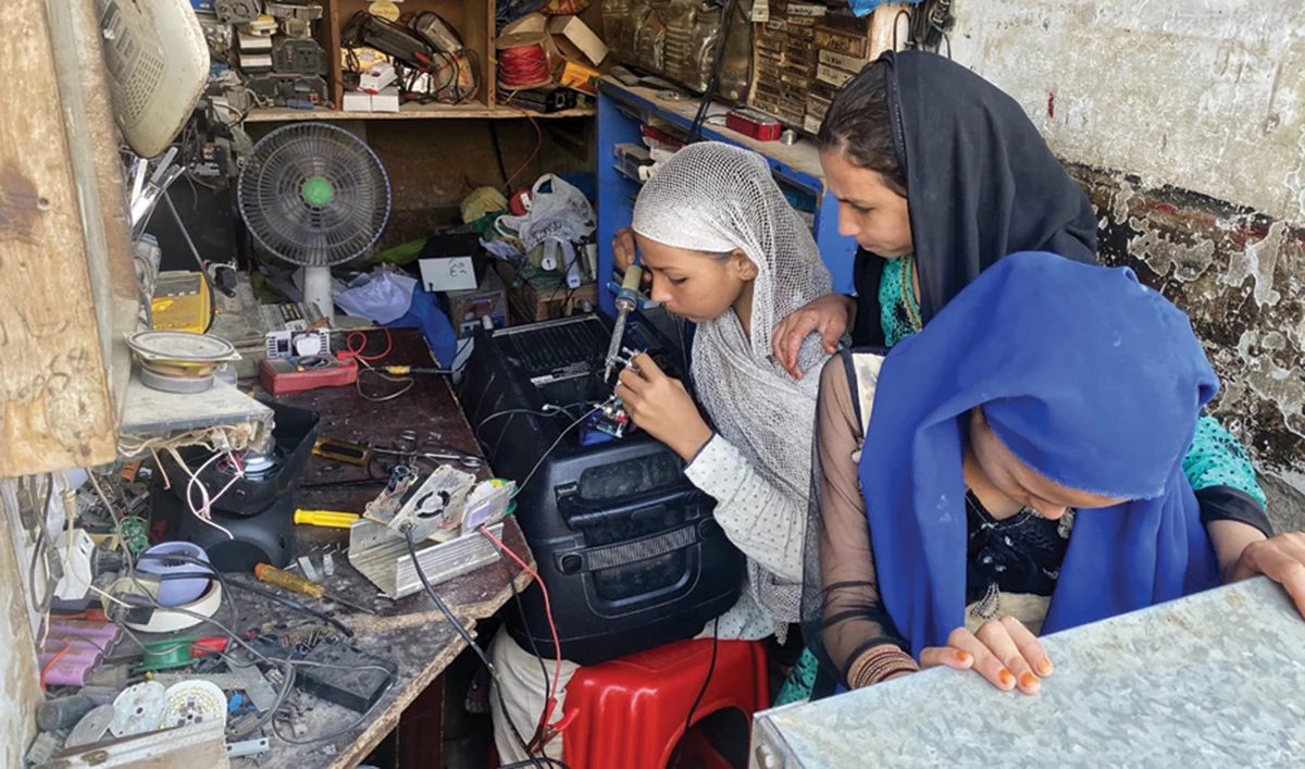 Javeriah Jamal at work in their father Naseeb Jamal’s shop in Qasba colony, Karachi. (AP)