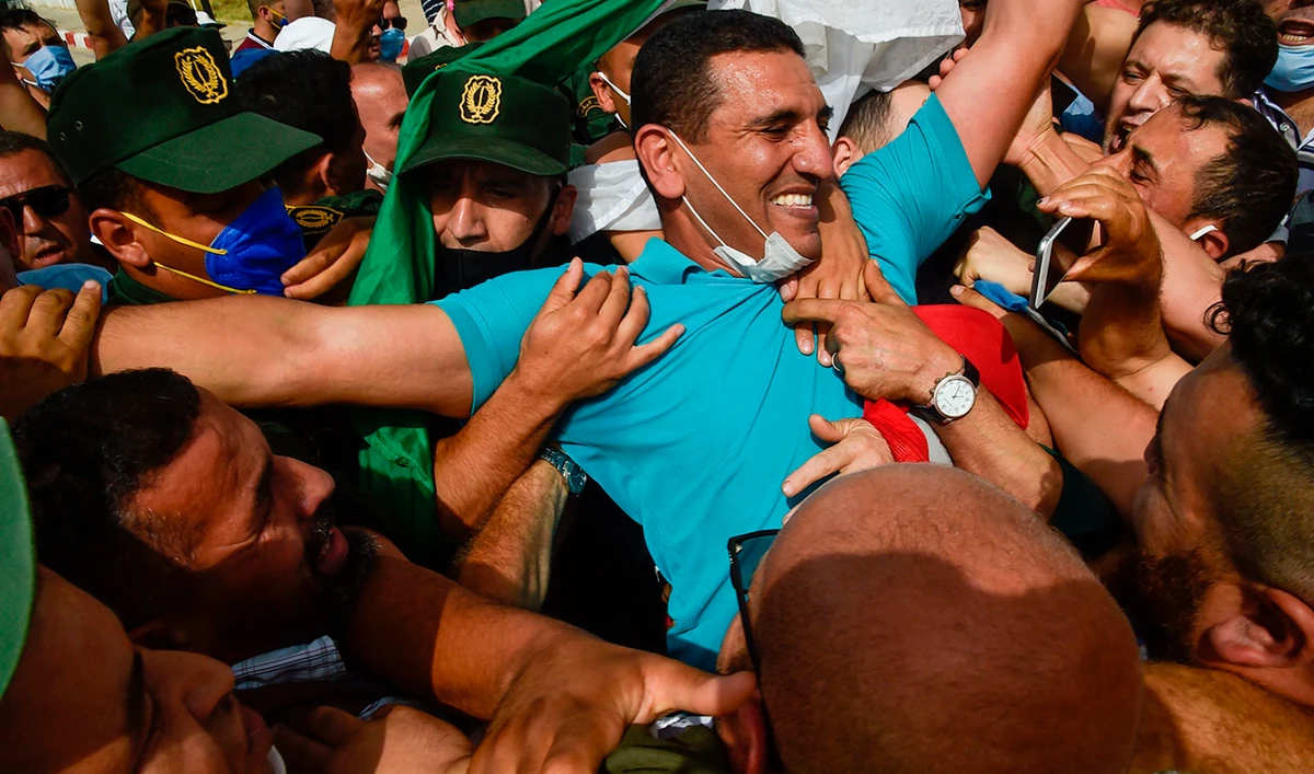 In this file photo taken on July 2, 2020 Karim Tabbou, one of the most prominent figures of "Hirak", gestures upon his release from prison. (AFP)